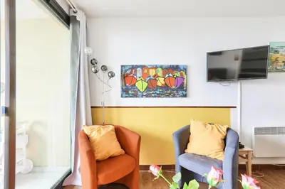 a living room with two chairs and a tv at Résidence Cannes Villa Francia - maeva Home - Appartement 2 Pièces 4 Personnes - Prestige MAE-8674 in Cannes