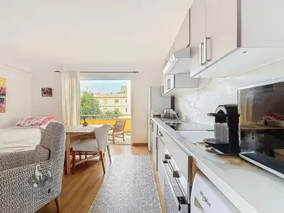 a kitchen with a table and a dining room at Océan front apartment in Cannes