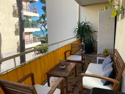 a balcony with chairs and tables on a building at Océan front apartment in Cannes