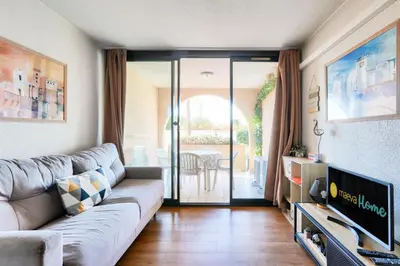 a living room with a couch and a television at Résidence Cannes Verrerie - maeva Home - Appartement climatisé 2 pièces 4 personnes - Sélection MAE-2064 in Cannes