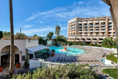 a view of a hotel with a pool and chairs at Résidence Cannes Verrerie - maeva Home - Appartement climatisé 2 pièces 4 personnes - Sélection MAE-2064 in Cannes