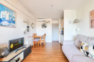 a living room with a couch and a table at Résidence Cannes Verrerie - maeva Home - Appartement climatisé 2 pièces 4 personnes - Sélection MAE-2064 in Cannes