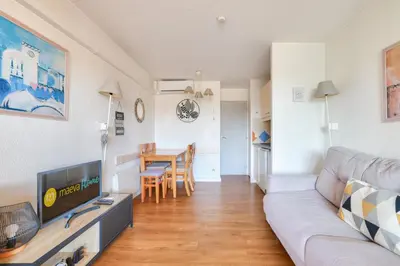 a living room with a couch and a table at Résidence Cannes Verrerie - maeva Home - Appartement climatisé 2 pièces 4 personnes - Sélection MAE-2064 in Cannes
