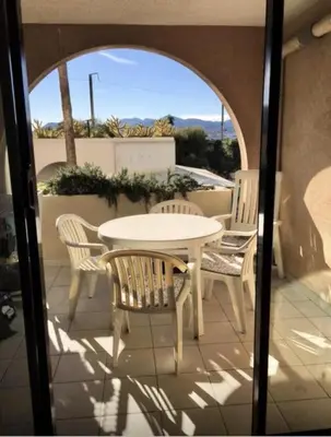 a white table and chairs on a patio at Résidence Cannes Verrerie - maeva Home - Appartement climatisé 2 pièces 4 personnes - Sélection MAE-2064 in Cannes