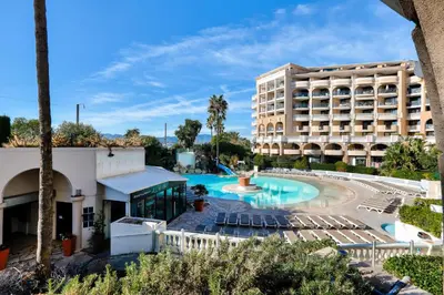a resort with a pool and chairs and a building at Résidence Cannes Verrerie - maeva Home - Appartement climatisé 2 pièces 4 personnes - Sélection MAE-2064 in Cannes