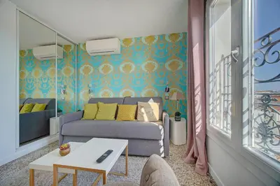 a living room with a bed and a table at Le Louvre Top Floor in Cannes