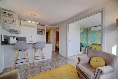 a living room with a couch and a chair at Le Louvre Top Floor in Cannes