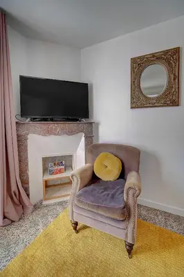 a living room with a chair and a fireplace at Le Louvre Top Floor in Cannes