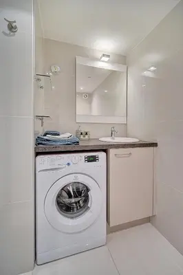 a white laundry room with a washing machine and a sink at Le Louvre Top Floor in Cannes