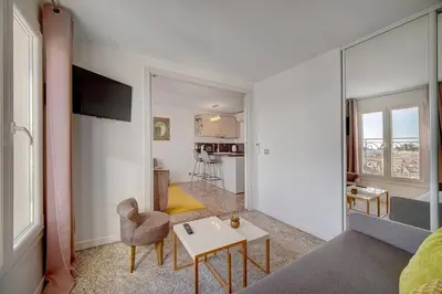 a living room with a couch and a table at Le Louvre Top Floor in Cannes