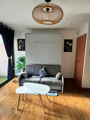 a living room with a couch and a table at PISCINE Plages à 100 m, palais des festivals à 15mn à pied dans la banane in Cannes