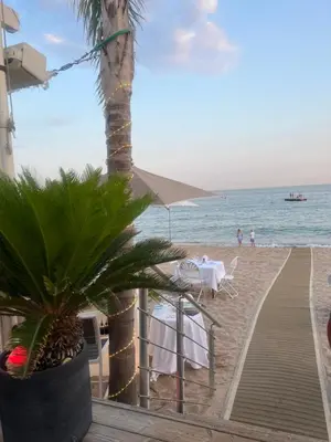 a table and chairs on the beach next to the ocean at PISCINE Plages à 100 m, palais des festivals à 15mn à pied dans la banane in Cannes