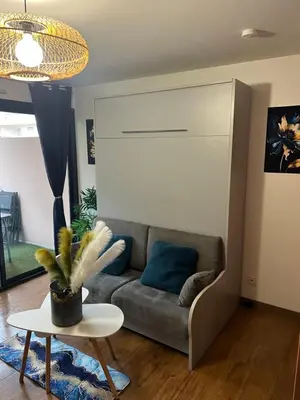a living room with a couch and a table at PISCINE Plages à 100 m, palais des festivals à 15mn à pied dans la banane in Cannes