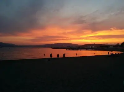 a group of people on the beach at sunset at Bright apartment - Cannes, la Croisette in Cannes