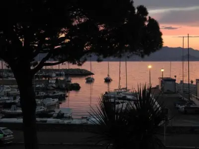 a group of boats docked in a marina at sunset at Bright apartment - Cannes, la Croisette in Cannes