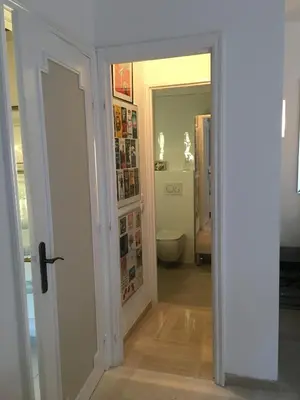 a hallway with a bathroom with a toilet and a door at Parc De La Croisette in Cannes