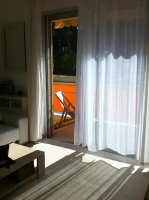 a living room with a door open to a patio at Parc De La Croisette in Cannes