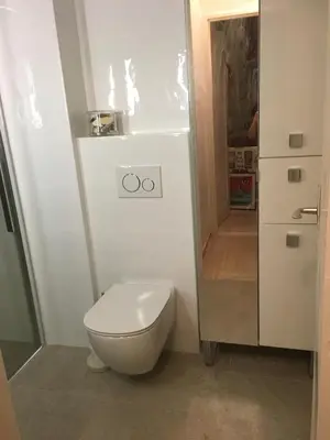 a white bathroom with a toilet and a shower at Parc De La Croisette in Cannes