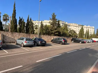 a row of cars parked in a parking lot at Parc De La Croisette in Cannes