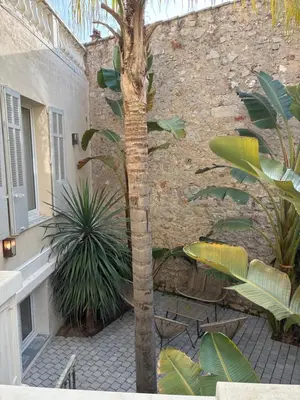 a staircase leading to a house with palm trees at Villa les Fougeres Studio jardin in Cannes