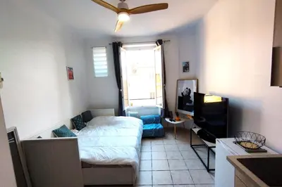 a small room with a bed and a television at Charming Studio ideal for Congresses and Holidays LIVE IN GAZAGNAIRE in Cannes