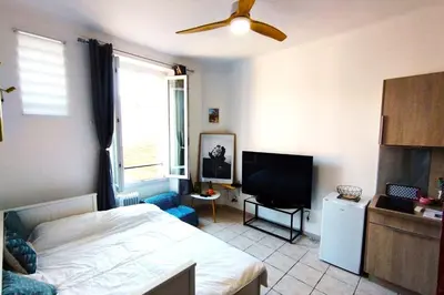 a bedroom with a bed and a flat screen tv at Charming Studio ideal for Congresses and Holidays LIVE IN GAZAGNAIRE in Cannes