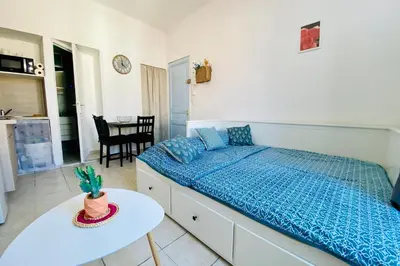 a bedroom with a bed and a table in it at Charming Studio ideal for Congresses and Holidays LIVE IN GAZAGNAIRE in Cannes