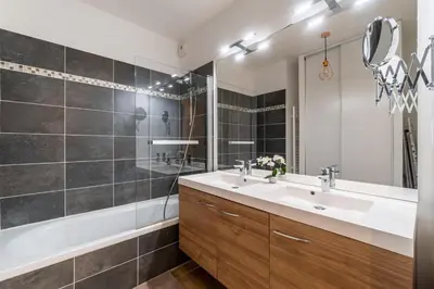 a bathroom with a sink and a tub and a mirror at La Villa Gauguin in Le Cannet