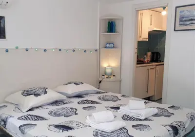 a bed with pillows on it in a room at Studio at -La Croisette- Cannes - BEACH GARDEN - in Cannes