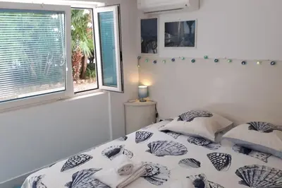 a bedroom with a bed and a window at Studio at -La Croisette- Cannes - BEACH GARDEN - in Cannes