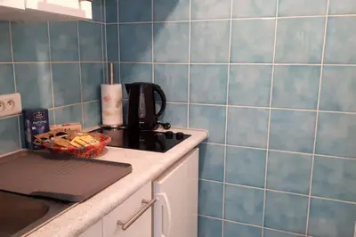 a kitchen with blue tiled walls and a stove top oven at Studio at -La Croisette- Cannes - BEACH GARDEN - in Cannes