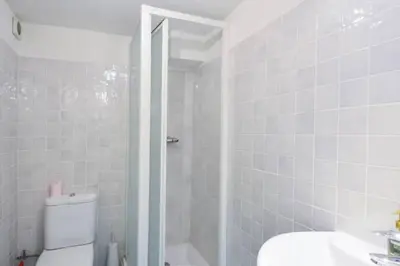 a white bathroom with a shower and a toilet at Studio at -La Croisette- Cannes - BEACH GARDEN - in Cannes