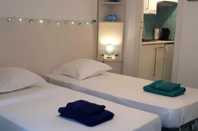 two beds with towels on them in a room at Studio at -La Croisette- Cannes - BEACH GARDEN - in Cannes