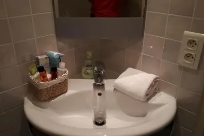a bathroom sink with a towel and a basket on it at Studio at -La Croisette- Cannes - BEACH GARDEN - in Cannes