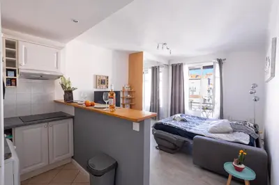 a kitchen and a bedroom with a bed in a room at Cannes centre apartment with a balcony in Cannes