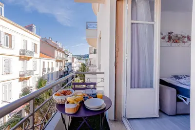 a balcony with a table with food on it at Cannes centre apartment with a balcony in Cannes