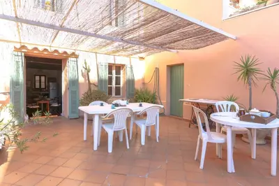 an outdoor patio with white tables and chairs at Apartment in the heart of Le Cannet with AC TERRACE BENAKEY in Le Cannet