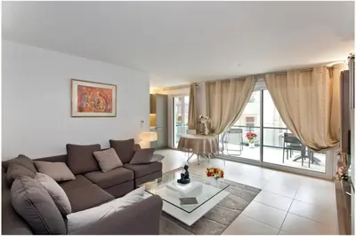 a living room with a couch and a table at REF 912 - Cannes Center - Apartment for rent in Cannes