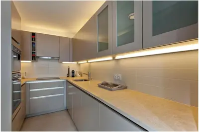 a kitchen with white cabinets and a sink at REF 912 - Cannes Center - Apartment for rent in Cannes