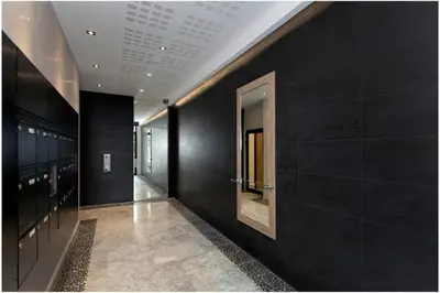 a hallway with black walls and a mirror at REF 912 - Cannes Center - Apartment for rent in Cannes