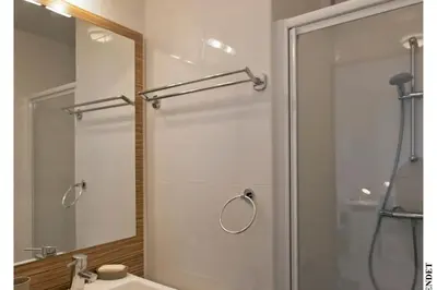 a bathroom with a shower with a mirror and a sink at REF 912 - Cannes Center - Apartment for rent in Cannes