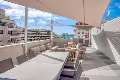 a balcony with tables and chairs on a building at REF 1071 - Cannes Center - 5mins to the Palais des Festivals in Cannes