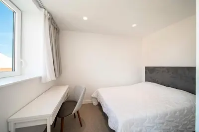 a bedroom with a bed and a desk and a window at REF 1071 - Cannes Center - 5mins to the Palais des Festivals in Cannes