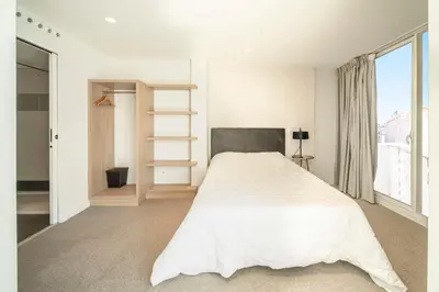 a bedroom with a white bed and a window at REF 1071 - Cannes Center - 5mins to the Palais des Festivals in Cannes