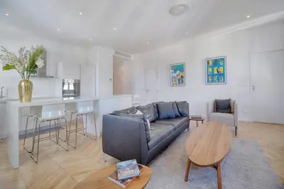 a living room with a couch and a table at REF 909 - Cannes Back Croisette - Apartment for rent in Cannes