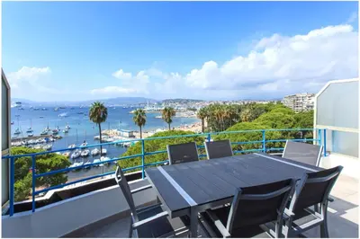a table and chairs on a balcony with a view of the water at REF 1229 - Cannes Croisette - Sea view apartment for rent in Cannes