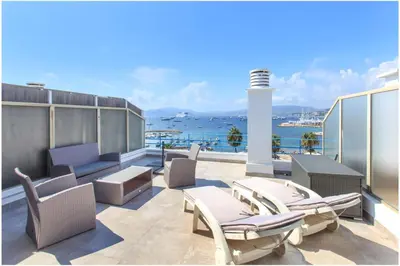 a balcony with chairs and a view of the ocean at REF 1229 - Cannes Croisette - Sea view apartment for rent in Cannes