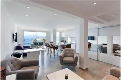 a living room with a kitchen and a dining room at REF 1229 - Cannes Croisette - Sea view apartment for rent in Cannes