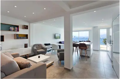 a living room with a couch and a table at REF 1229 - Cannes Croisette - Sea view apartment for rent in Cannes