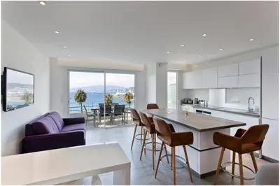 a kitchen and living room with a table and chairs at REF 1229 - Cannes Croisette - Sea view apartment for rent in Cannes